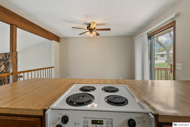 2211 Scarborough Dr, Bellevue, NE 68123 - kitchen with white electric range oven, ceiling fan, light countertops, and beamed ceiling