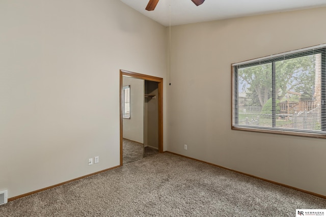 2211 Scarborough Dr, Bellevue, NE 68123 - carpeted spare room featuring ceiling fan, baseboards, and high vaulted ceiling