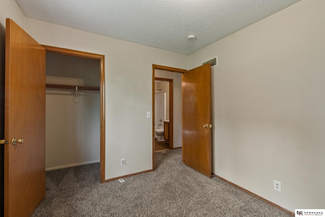 2211 Scarborough Dr, Bellevue, NE 68123 - unfurnished bedroom with carpet floors, a closet, baseboards, and a textured ceiling