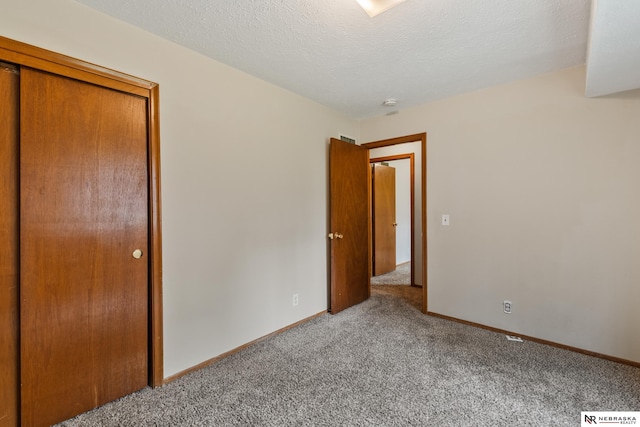 2211 Scarborough Dr, Bellevue, NE 68123 - unfurnished bedroom featuring carpet flooring, baseboards, and a textured ceiling