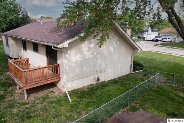 2211 Scarborough Dr, Bellevue, NE 68123 - view of home's exterior featuring a deck, a shingled roof, and a chimney