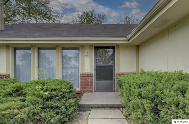 2211 Scarborough Dr, Bellevue, NE 68123 - doorway to property featuring brick siding and roof with shingles