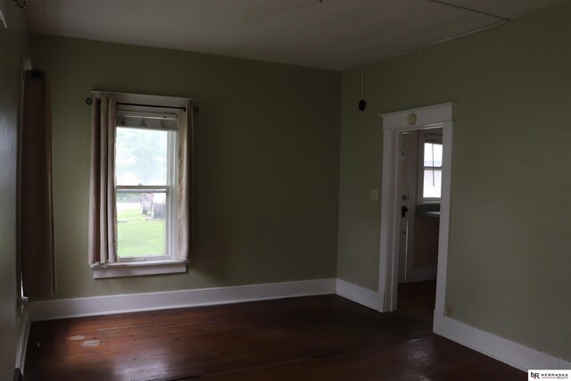 1535 N 32nd St, Lincoln, NE 68503 - empty room featuring dark wood-style flooring and baseboards