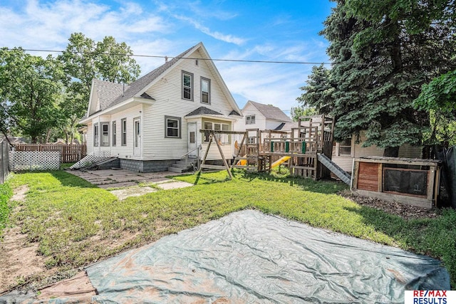 240 E 15th St, Fremont, NE 68025 - rear view of property featuring a playground and roof with shingles