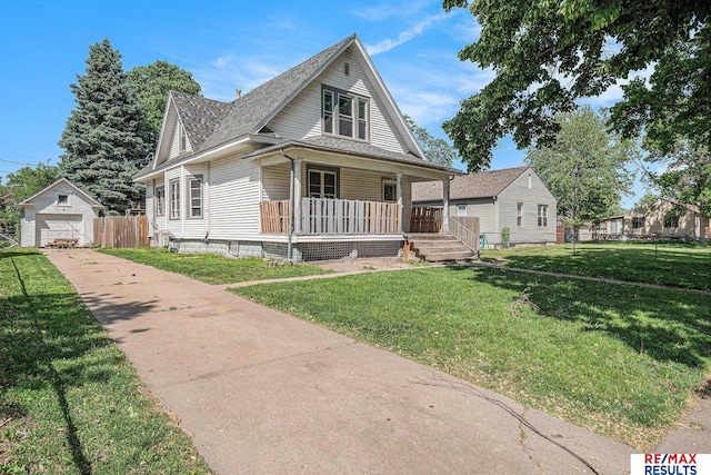 240 E 15th St, Fremont, NE 68025 - bungalow-style house with covered porch, driveway, a detached garage, an outbuilding, and roof with shingles