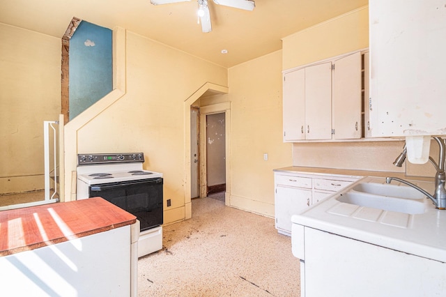 240 E 15th St, Fremont, NE 68025 - kitchen with electric range, light countertops, white cabinetry, a sink, and ceiling fan