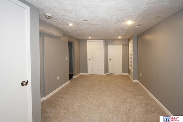 4530 N 72nd St, Lincoln, NE 68507 - finished below grade area with light carpet, baseboards, a textured ceiling, and recessed lighting