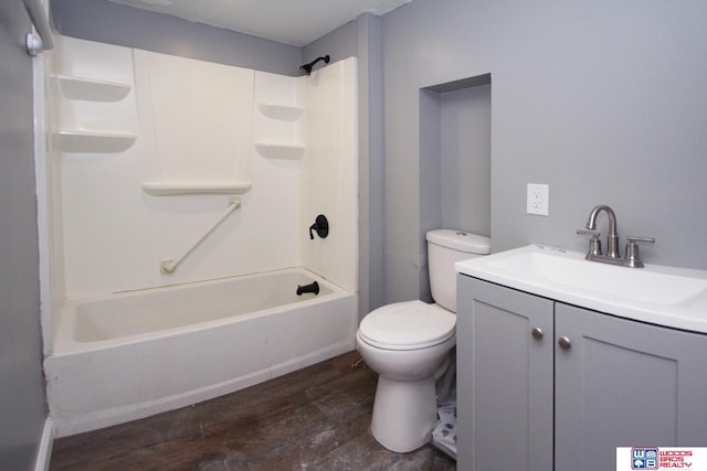 4530 N 72nd St, Lincoln, NE 68507 - bathroom with wood finished floors, toilet, vanity, and tub / shower combination