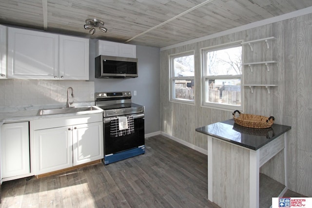 4530 N 72nd St, Lincoln, NE 68507 - kitchen with stainless steel appliances, a sink, white cabinetry, dark wood-style floors, and backsplash