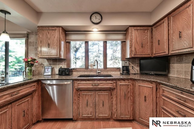 15708 Leavenworth St, Omaha, NE 68118 - kitchen featuring stainless steel dishwasher, a sink, brown cabinets, and plenty of natural light