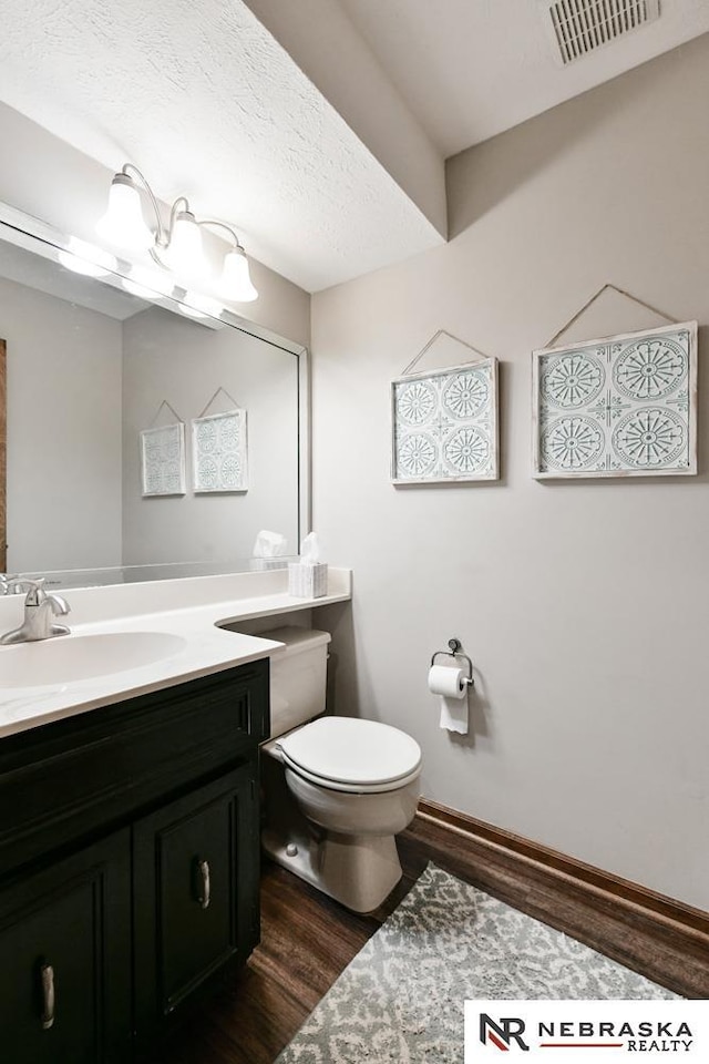 15708 Leavenworth St, Omaha, NE 68118 - bathroom featuring toilet, wood finished floors, vanity, and baseboards
