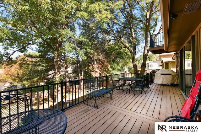 15708 Leavenworth St, Omaha, NE 68118 - wooden terrace featuring outdoor dining area and a grill