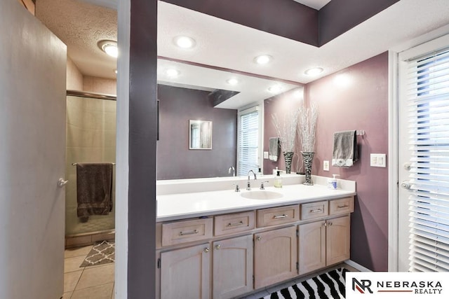 15708 Leavenworth St, Omaha, NE 68118 - full bath featuring vanity, a stall shower, tile patterned floors, and recessed lighting