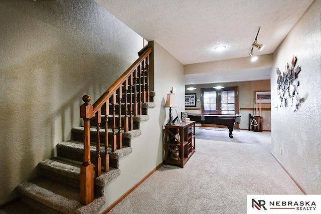 15708 Leavenworth St, Omaha, NE 68118 - stairs with carpet flooring, a textured wall, a textured ceiling, billiards table, and baseboards