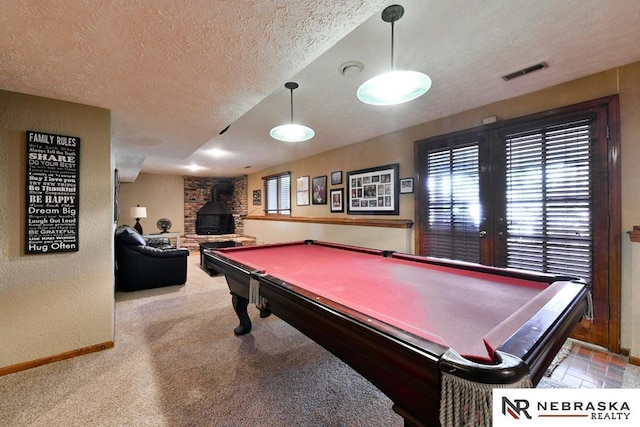 15708 Leavenworth St, Omaha, NE 68118 - recreation room with a textured ceiling, a wood stove, baseboards, pool table, and carpet flooring