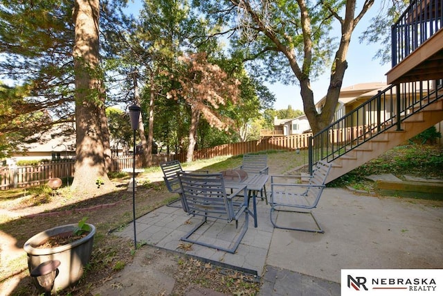 15708 Leavenworth St, Omaha, NE 68118 - fenced backyard featuring stairway, outdoor dining area, and a patio area