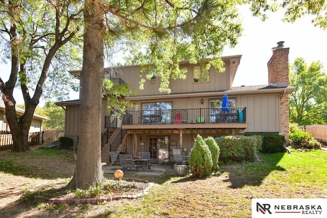 15708 Leavenworth St, Omaha, NE 68118 - back of house featuring a patio area, a chimney, a wooden deck, and stairs