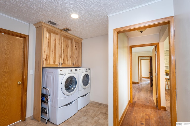 13205 N 192nd St, Bennington, NE 68007 - laundry area featuring washer and dryer, cabinet space, baseboards, an ornate ceiling, and light wood finished floors