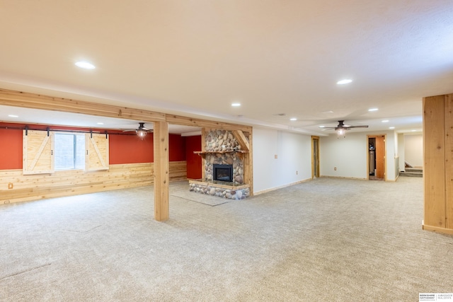 13205 N 192nd St, Bennington, NE 68007 - below grade area with carpet flooring, wood walls, a fireplace, recessed lighting, and ceiling fan