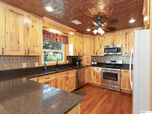13205 N 192nd St, Bennington, NE 68007 - kitchen featuring appliances with stainless steel finishes, a sink, an ornate ceiling, backsplash, and wood finished floors