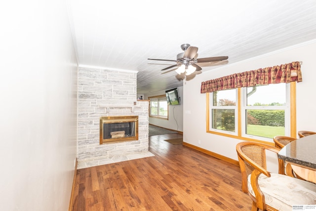 13205 N 192nd St, Bennington, NE 68007 - living room with a fireplace, a ceiling fan, wood finished floors, baseboards, and ornamental molding