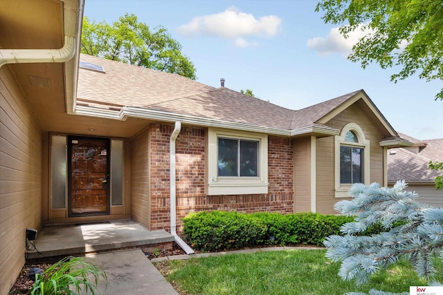 14460 Patrick Ave, Omaha, NE 68116 - property entrance with a shingled roof and brick siding