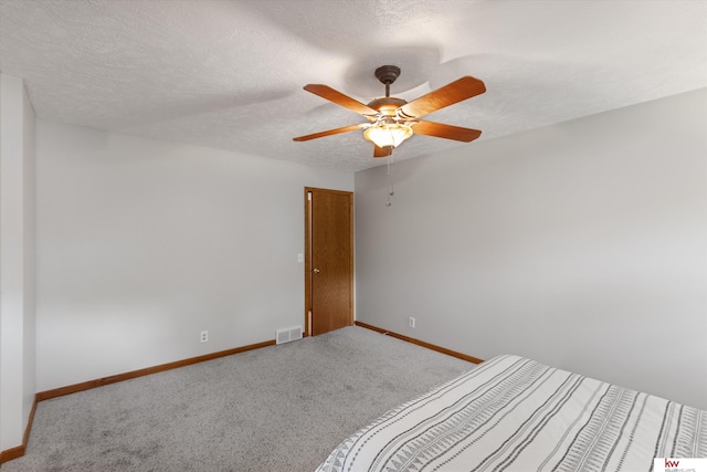14460 Patrick Ave, Omaha, NE 68116 - unfurnished bedroom with baseboards, carpet flooring, ceiling fan, and a textured ceiling