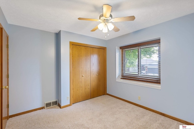 14460 Patrick Ave, Omaha, NE 68116 - unfurnished bedroom featuring carpet floors, a closet, baseboards, and a ceiling fan