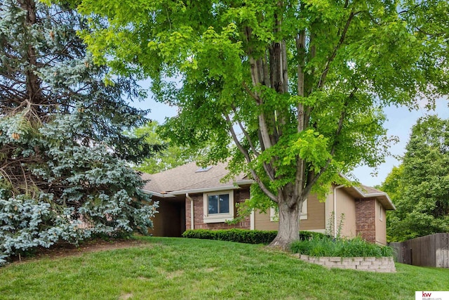 14460 Patrick Ave, Omaha, NE 68116 - obstructed view of property featuring brick siding and roof with shingles