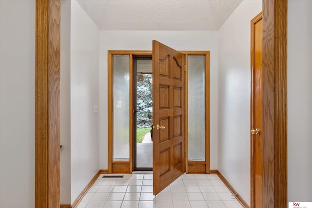 14460 Patrick Ave, Omaha, NE 68116 - entryway with baseboards, light tile patterned floors, and a textured ceiling