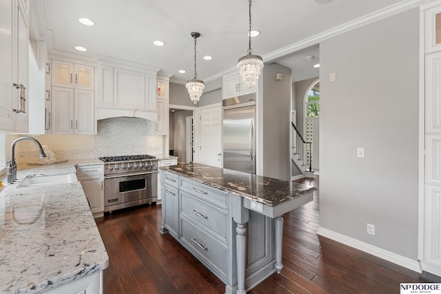 15921 Lake St, Omaha, NE 68116 - kitchen with high quality appliances, a sink, tasteful backsplash, baseboards, and light stone countertops