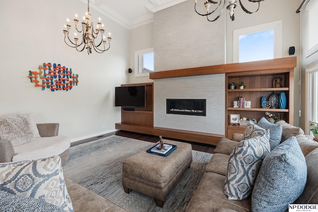 15921 Lake St, Omaha, NE 68116 - living area featuring a chandelier, crown molding, wood finished floors, a glass covered fireplace, and baseboards