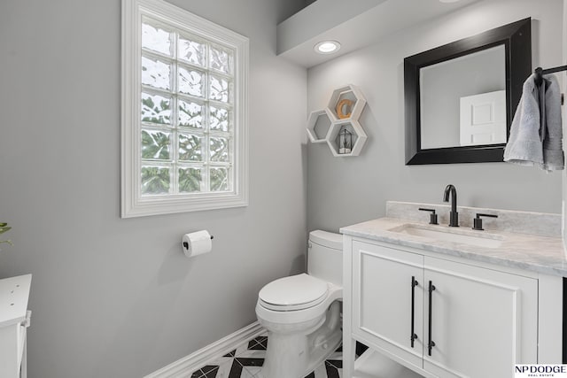 15921 Lake St, Omaha, NE 68116 - bathroom featuring toilet, baseboards, vanity, and healthy amount of natural light