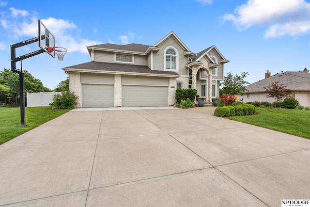 15921 Lake St, Omaha, NE 68116 - traditional-style house with concrete driveway, brick siding, an attached garage, and roof with shingles