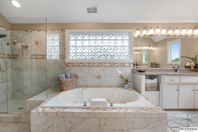 15921 Lake St, Omaha, NE 68116 - full bath featuring a stall shower, vanity, a jetted tub, and tile patterned flooring
