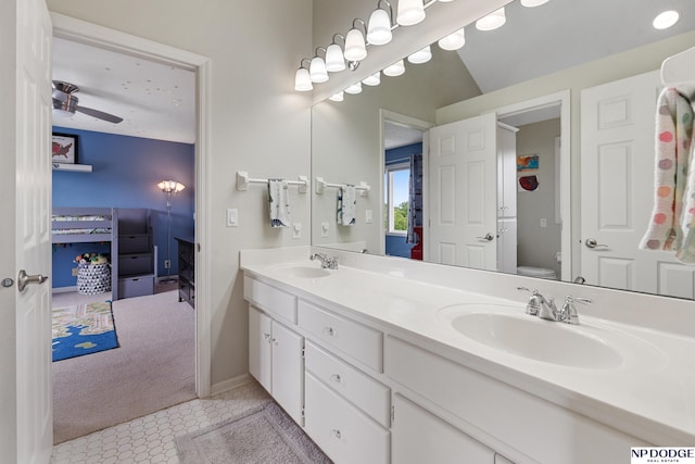 15921 Lake St, Omaha, NE 68116 - bathroom featuring double vanity, toilet, baseboards, and connected bathroom