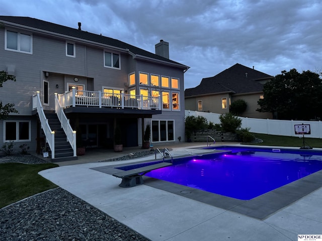 15921 Lake St, Omaha, NE 68116 - view of swimming pool featuring stairway, a patio area, a wooden deck, and a diving board
