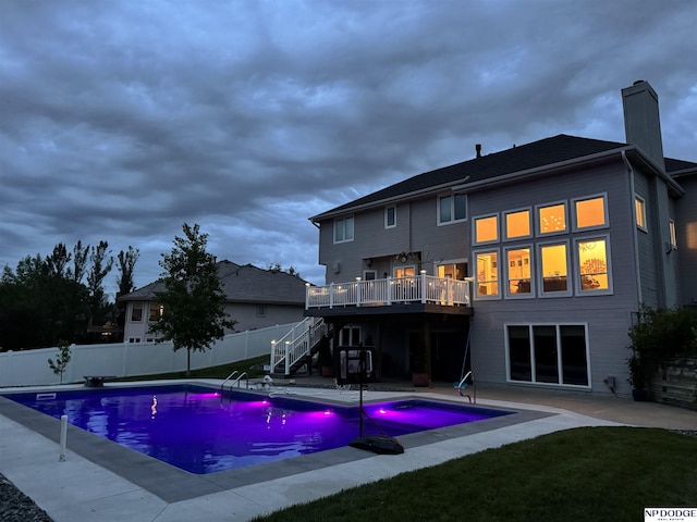 15921 Lake St, Omaha, NE 68116 - view of swimming pool with stairs, a wooden deck, and a patio area