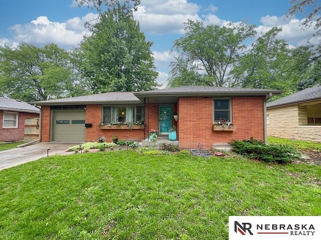 3840 X St, Lincoln, NE 68503 - single story home with an attached garage, concrete driveway, brick siding, and a front yard