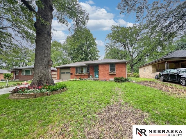 3840 X St, Lincoln, NE 68503 - view of front of house with an attached garage, brick siding, and a front yard