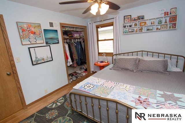 3840 X St, Lincoln, NE 68503 - bedroom featuring a closet, wood finished floors, baseboards, and ceiling fan