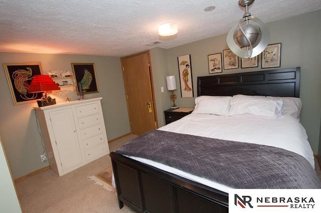 3840 X St, Lincoln, NE 68503 - bedroom featuring light colored carpet, a textured ceiling, and baseboards