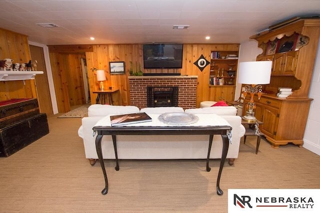 3840 X St, Lincoln, NE 68503 - living area featuring a fireplace, wood walls, and light colored carpet