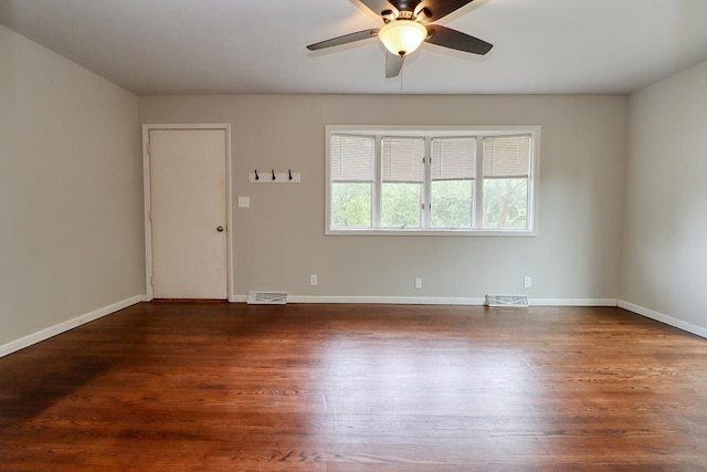 3831 S 54th St, Lincoln, NE 68506 - spare room with ceiling fan, dark wood finished floors, and baseboards