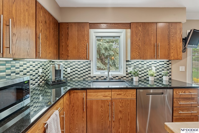 9911 Devonshire Dr, Omaha, NE 68114 - kitchen featuring appliances with stainless steel finishes, a sink, backsplash, and brown cabinetry