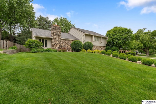 9911 Devonshire Dr, Omaha, NE 68114 - view of front facade featuring stone siding and a chimney