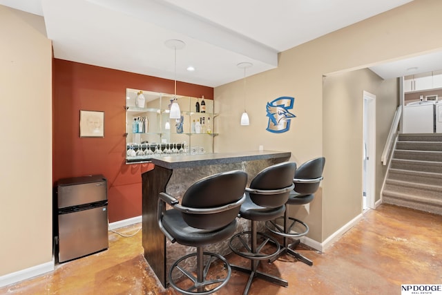 9911 Devonshire Dr, Omaha, NE 68114 - indoor bar featuring baseboards, freestanding refrigerator, stairs, finished concrete floors, and washer / clothes dryer