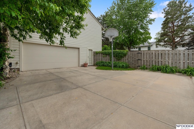 9911 Devonshire Dr, Omaha, NE 68114 - view of property exterior with a garage and concrete driveway