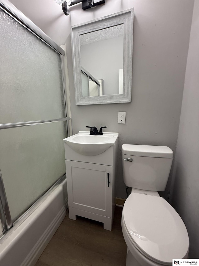 1322 S 21st St, Omaha, NE 68108 - full bathroom with vanity, shower / bath combination with glass door, toilet, and wood finished floors