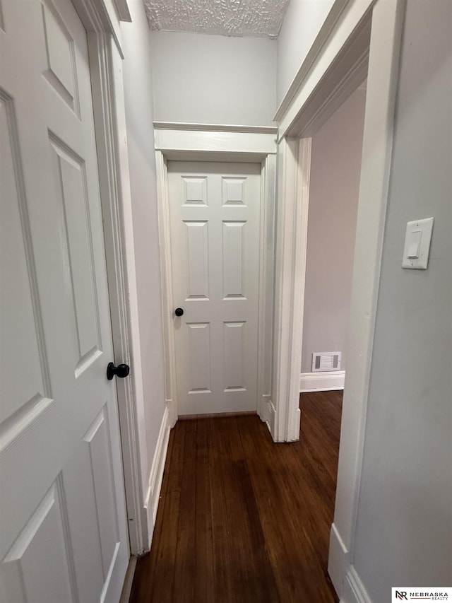 1322 S 21st St, Omaha, NE 68108 - hallway featuring dark wood-type flooring and baseboards